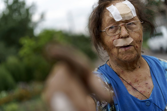 Valentyna Kondratieva, 75, points to her damaged home, Saturday, Aug. 13, 2022, where she sustained injuries in a Russian rocket attack last night in Kramatorsk, Donetsk region.