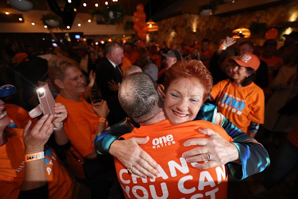 Pauline Hanson embraces a supporter at the One Nation HQ party in Albury.