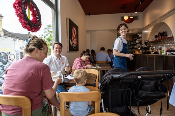 Cafe Lewi has sweeping arches and large windows framing sky.