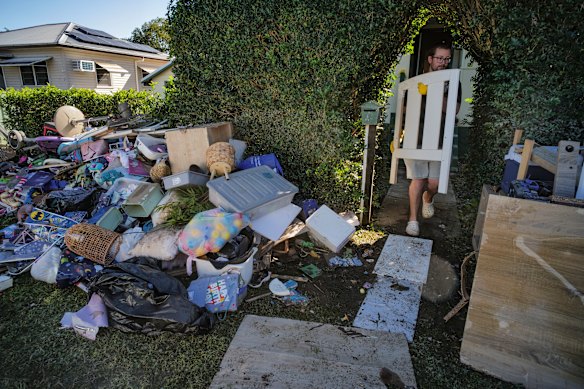 Residents in Taree begin the flood clean-up on Saturday. 