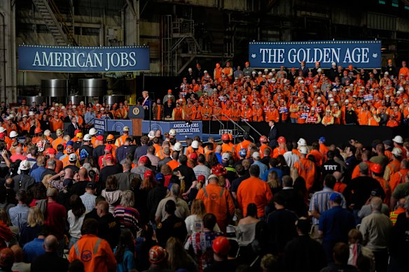 Workers listen to Trump as he announced a plan to double tariffs on steel imports.