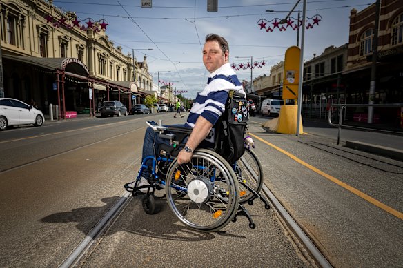 Andrew Bretherton at the tram stop outside North Melbourne Town Hall on Errol Street. That stop does not allow him to access trams.