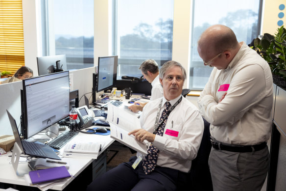 Journalists from The Sydney Morning Herald and The Age go over the budget documents in lock up.