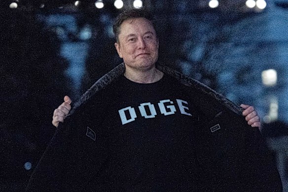Elon Musk flashes his “DOGE” T-shirt while at the White House.