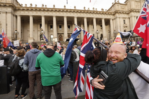 People attend a Daniel Andrews resignation celebration on the steps of Parliament House in Melbourne.