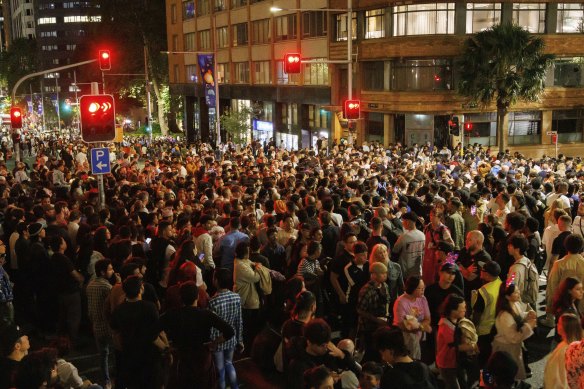 A crowd gathered at the intersection of Young St and Bridge St to try and get a glimpse of Sydney’s midnight New Year’s Eve fireworks.