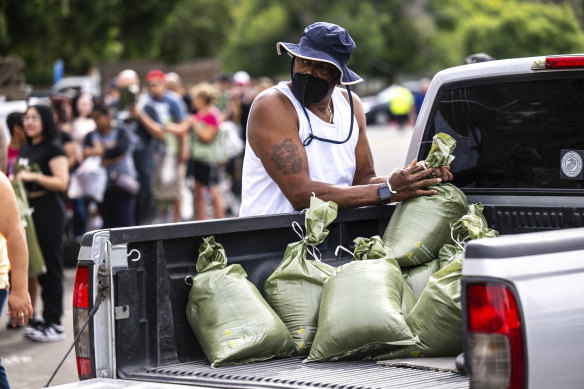 Ronald Thompkins, 60, loads sandbags in preparation for the arrival of Hurricane Hilary.