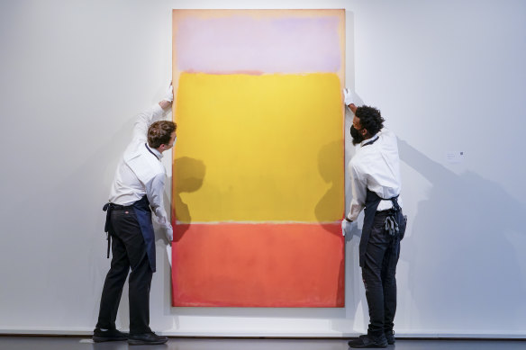 Art handlers adjust Mark Rothko’s “No. 7” at Sotheby’s auction house.