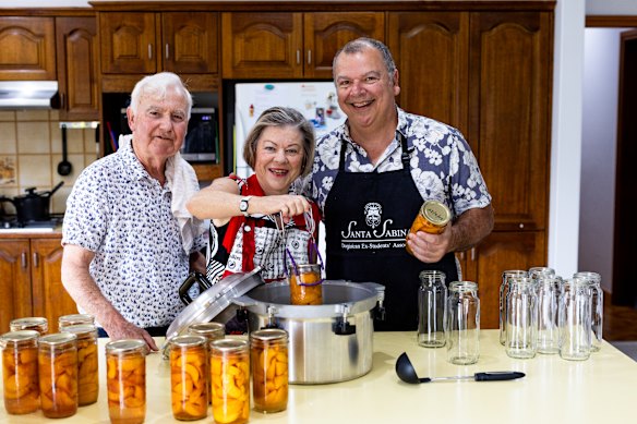 Mick and Maris Cummins show writer Andrew Hornery (right) their bottling system.