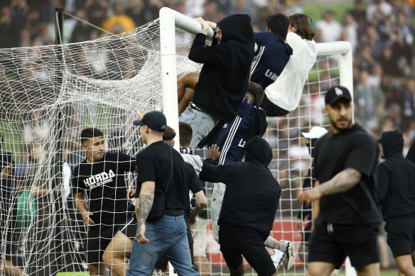 Fans storm the pitch at the A-League Men round eight Melbourne derby.