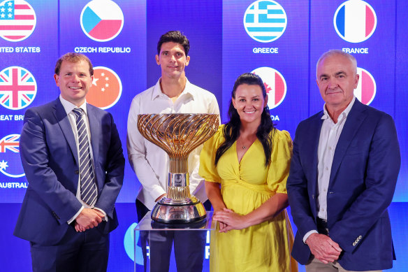 United Cup tournament director Stephen Farrow, Davis Cup champion and two-time grand slam singles finalist Mark Philippoussis, grand slam mixed doubles champion Casey Dellacqua and former professional tennis player and television commentator Wally Masur pose for a photo with the United Cup. 