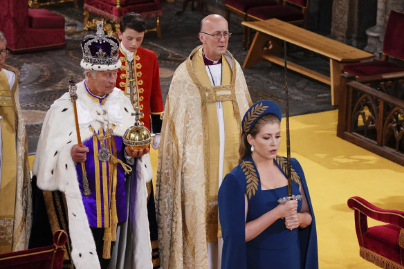 Lord President of the Council, Penny Mordaunt, walks ahead of King Charles III at his coronation.
