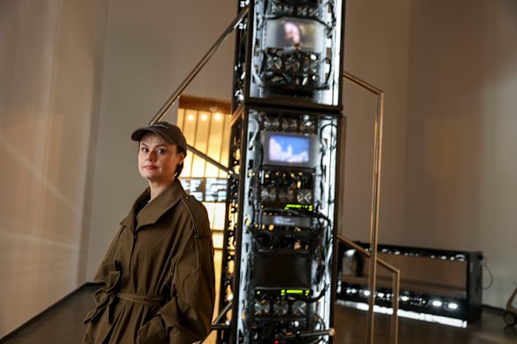 Artist Amanda Bennetts with her artwork about data centres at ACCA.
