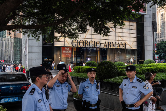 Police on patrol in a luxury shopping district of Chongqing, China, in 2018. The Chinese authorities have declared war on content deemed to be “flaunting wealth”.