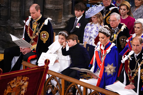 Prince Louis points to something on the ceiling of Westminster Abbey during the coronation of his grandfather, King Charles III.