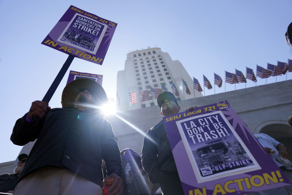 Workers picket outside of City Hall in Los Angeles.