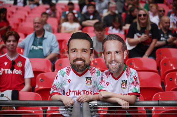 Fans with novelty masks of the pair at the FA Trophy final. 