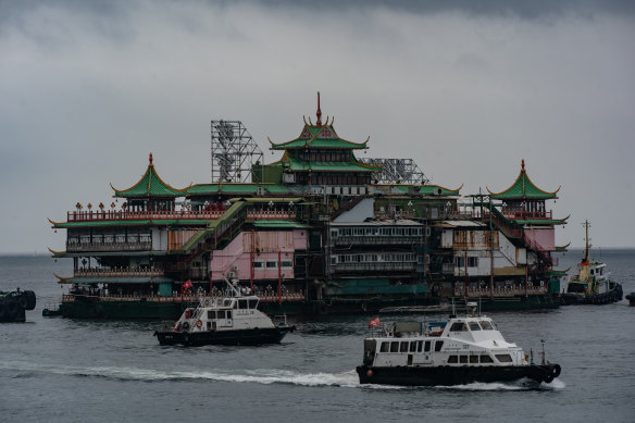 Tugboats tow the Chinese imperial-style Jumbo Floating Restaurant out of a typhoon shelter in Aberdeen on June 14, 2022 in Hong Kong, China. 