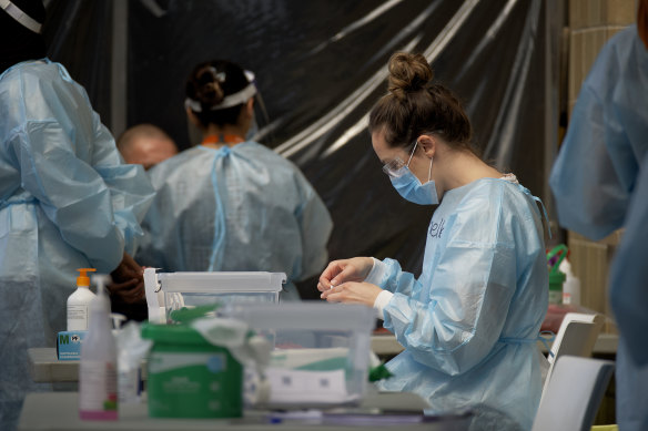 Nurses conduct COVID testing this week at a pop-up clinic in Heidelberg West.