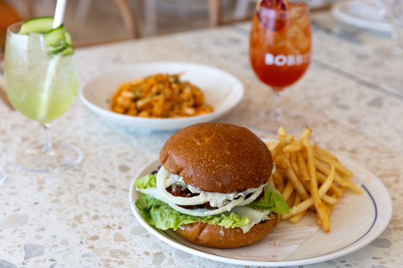 The barra burger with crumbed barramundi fillet, cos lettuce, white onion and a toasted milk bun.