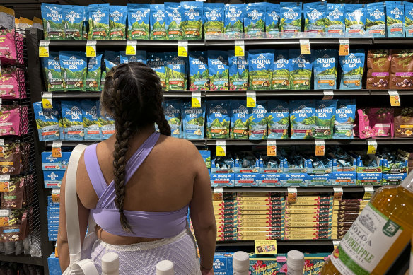 A shopper looks at the macadamia delicacies on offer in a Honolulu shop.