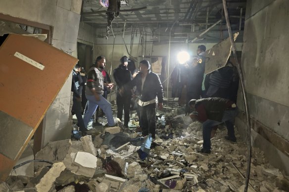 Rescue workers inspect a room at Nasser hospital after it was hit by a targeted Israeli army strike in Khan Younis on Sunday