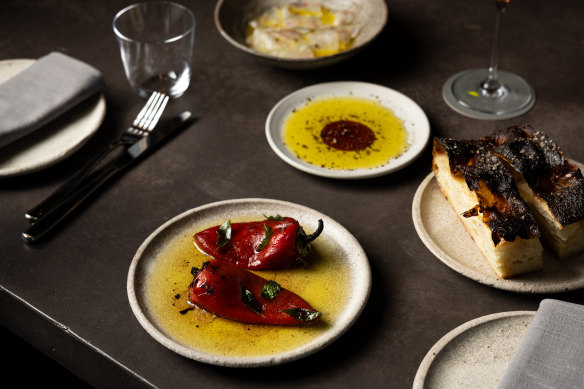A snack-heavy menu includes marinated peppers with curry leaf and house-baked focaccia.