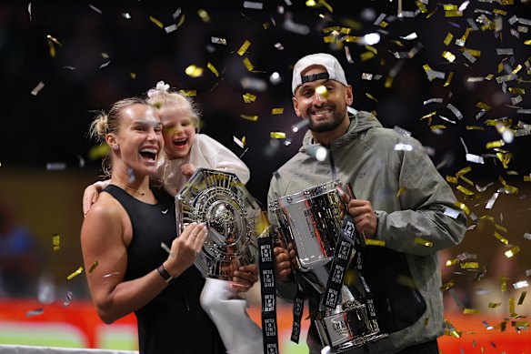 Aryna Sabalenka and Nick Kyrgios pose with their trophies.