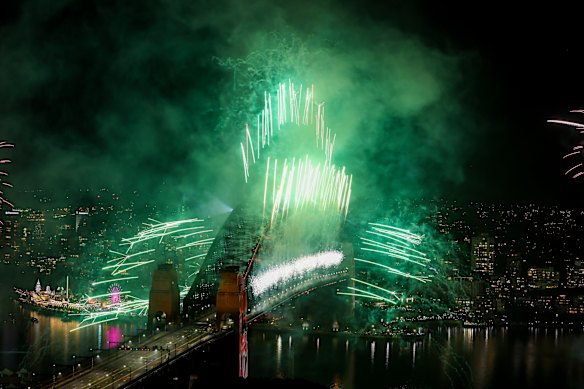 Green fireworks spread from all sides of the bridge.