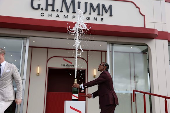 Isaac Quaynor copped a drenching from his champagne display.