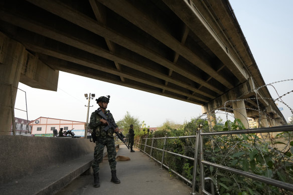 A Thai soldier keeps guard along the on the Thai side of the Moei river.