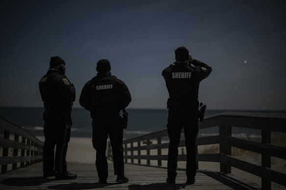 Ocean County sheriff’s officers scan the night sky for drones at Island Beach State Park, in Lanoka Harbour, N.J.