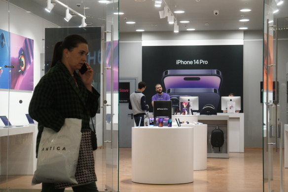A woman walks past a store promoting Apple iPhone 14 pro, at a shopping centre in Moscow, Russia. 