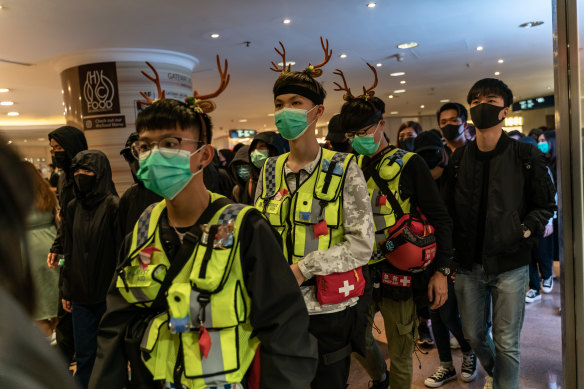 Volunteer medics stay close at hand during a demonstration inside a shopping mall on December 24 in Hong Kong.