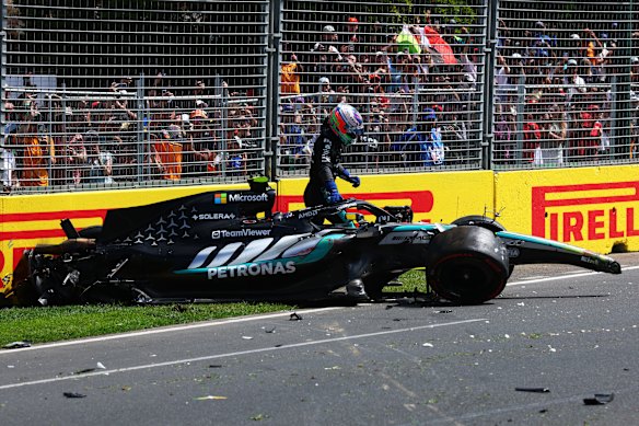 Kimi Antonelli surveys the damage of his smashed Mercedes after a crash in practice.