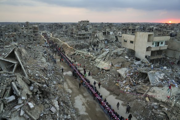 Palestinians in southern Gaza gather for iftar to break their fast on the first day of Ramadan on Saturday.