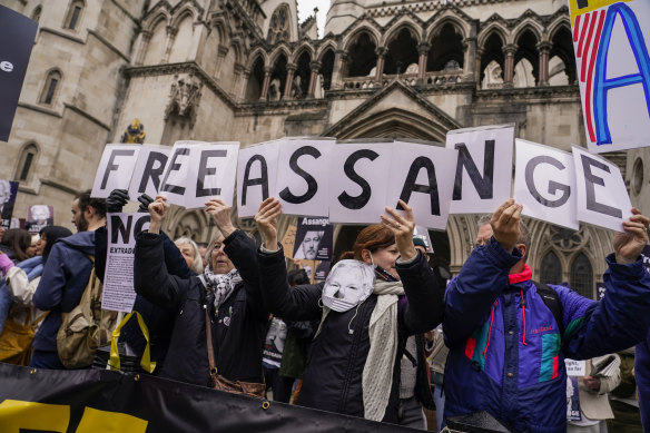 Demonstrators hold banners outside the Royal Courts of Justice in London. WikiLeaks founder Julian Assange will make his final appeal against his impending extradition to the United States at the court.