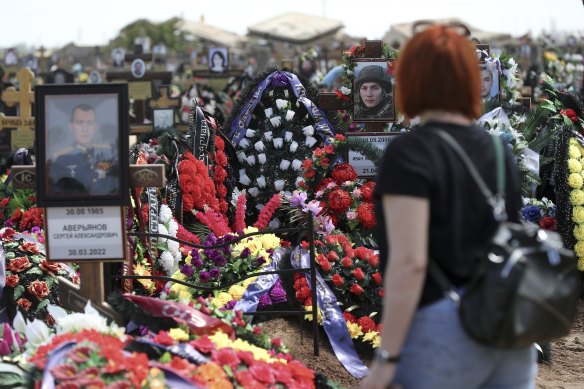 A woman visits the graves of Russian soldiers killed in Ukraine at a cemetery in Volzhsky, outside Volgograd, Russia, last year. Some experts say that Europe’s largest conflict since World War II could drag on for years. 