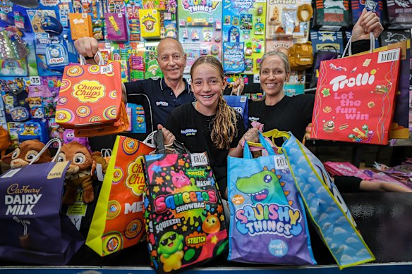 Samantha Atkinson, her father Marcus Atkinson and Samantha’s daughter Asher Gilbert, 12. Three generations of the Atkinson family are helping sell 250 lines of showbags at Melbourne Royal Show as part of a 70-year business, Bensons Trading, started by Samantha’s grandfather, William Atkinson.