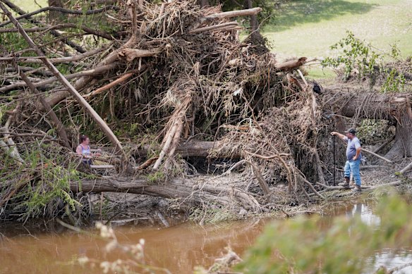 People search along the Guadalupe River after flooding in Kerrville, Texas, on Wednesday.