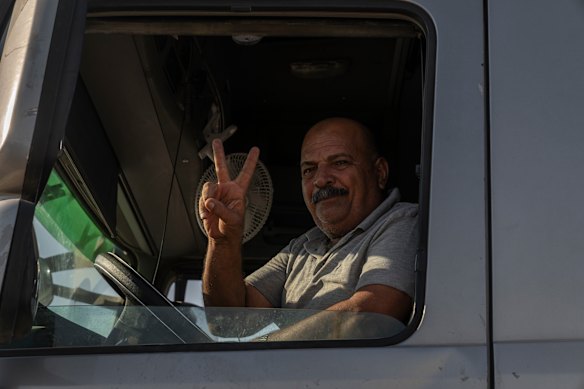 A truck driver carries aid across the border from Egypt into Gaza on Sunday.