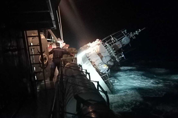 The HTMS Sukhothai corvette warship lists off the coast of Prachuap Khiri Khan province, Thailand, on Sunday night. It has now sunk.