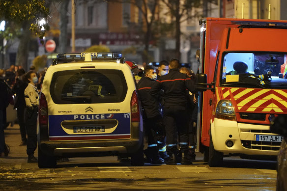 Police officers and rescue workers block the access to the scene after a Greek Orthodox priest was shot while he was closing his church in the city of Lyon, central France.
