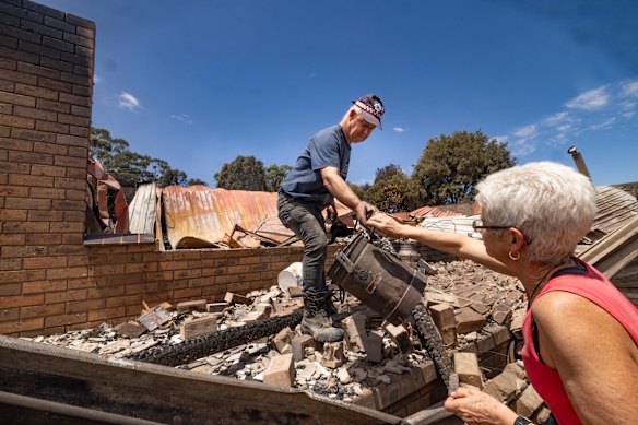 Tyrone and Raewyn Rice try to salvage what they can from the rubble.