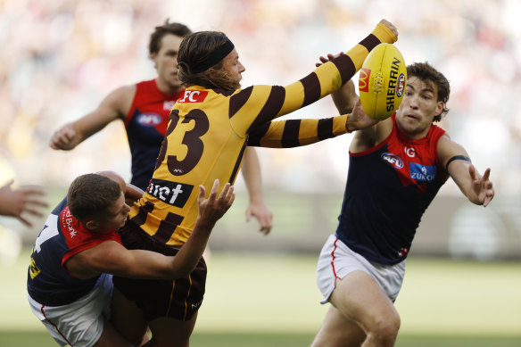 Jack Ginnivan attempts to gets a handball away for the Hawks.