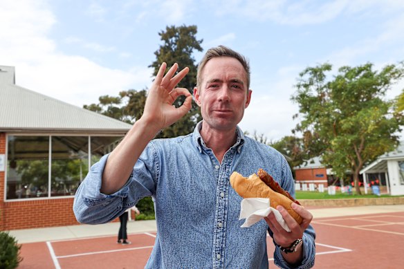 Curtin Liberal candidate Tom White approves his democracy sausage.