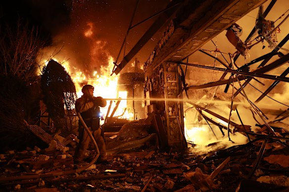 Firefighters try to put out a fire at a private house following a Russian drone attack in Zaporizhzhia, Ukraine.