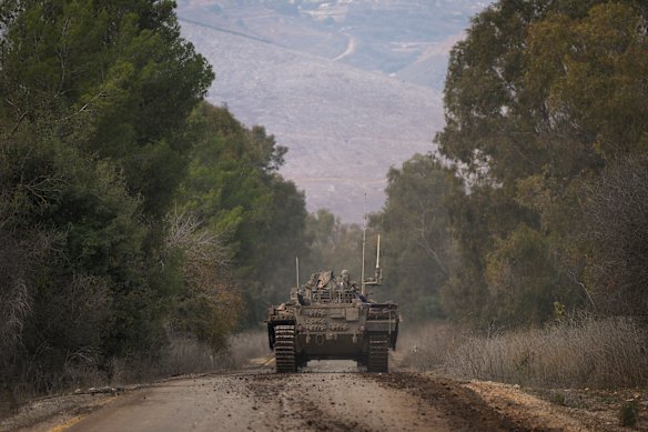 An Israeli army armoured vehicle drives along a road near the agricultural settlement of Avivim, next to the Lebanese border in northern Galilee, Israel.