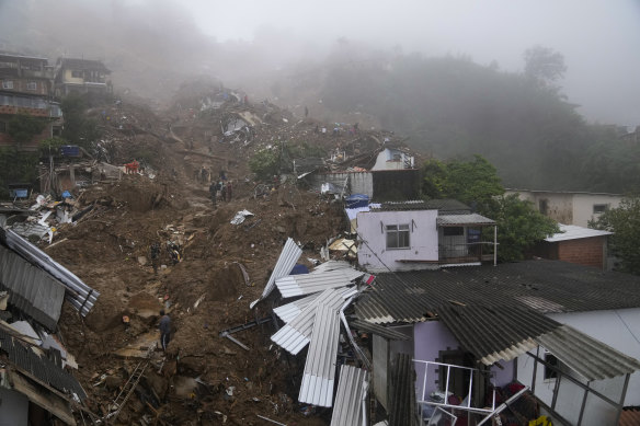 Rescue workers and residents search for survivors after mudslides in Petropolis, Brazil.