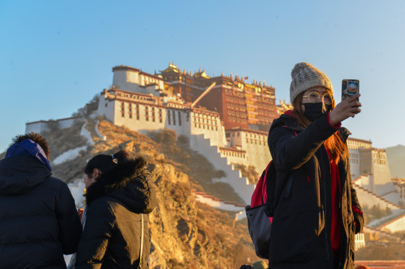 Tourists at the Potala Palace in Lhasa: the winter palace of the Dalai Lama since the 7th century, it is a UNESCO World Heritage site. The Dalai Lama lives in exile in India. 